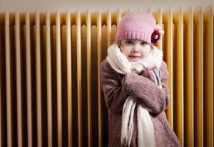 Cold Little Girl as heat pump blows cool air